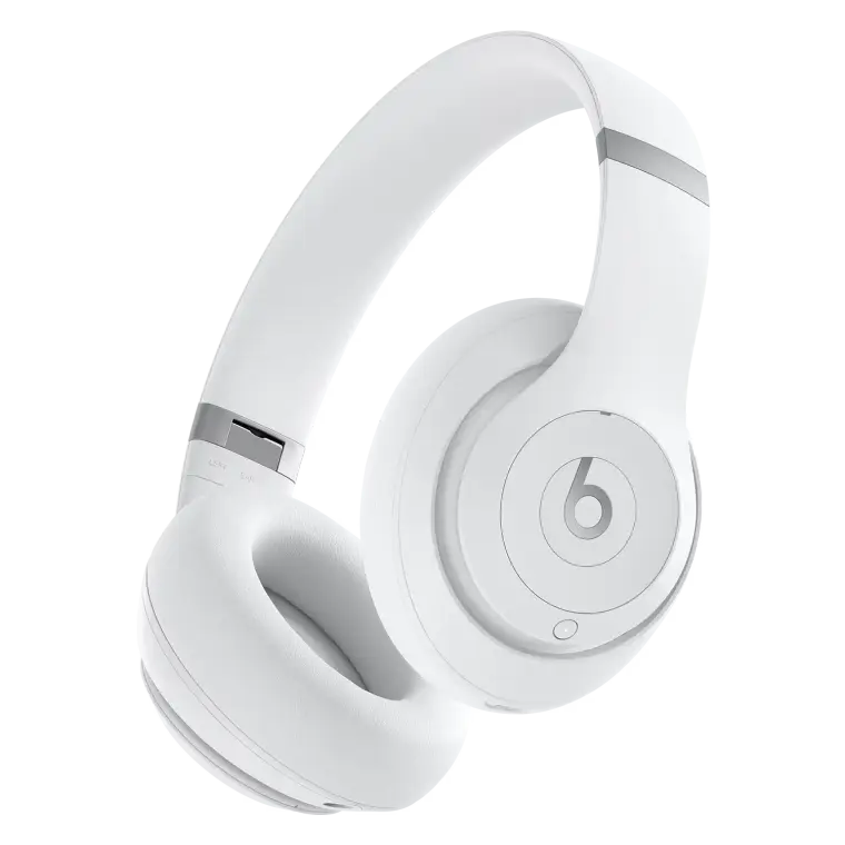 White Beats over-ear headphones shown at an angle against a black background, highlighting cushioned ear cups, headband, and iconic logo.
